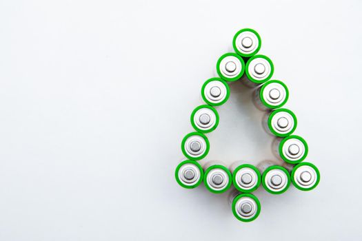 The batteries are in the shape of a Christmas tree on a white background. top view, flat lay, copy space, isolate. High quality photo