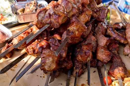 Fried kebab on skewers. Street food festival. Close-up. Selective focus.