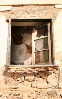 Broken and damaged window in an old house in Spain