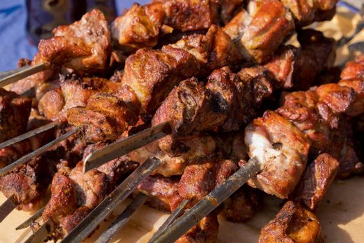 Fried kebab on skewers. Street food festival. Close-up. Selective focus.