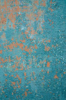 Vertical background old cracked paint on the fence, primer orange, peeling paint green