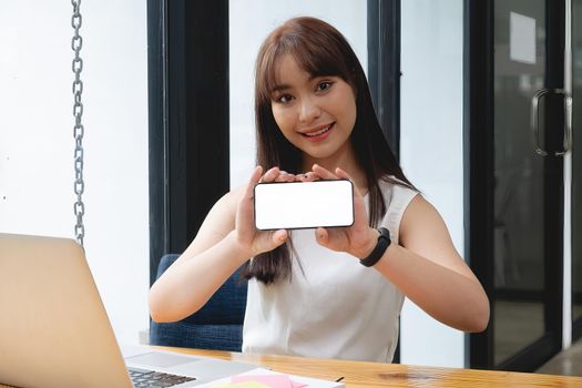 A Woman excited surprise and showing cell phone screen. Blank screen for your advertising