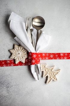 Festive place setting for holiday Christmas dinner on concrete table