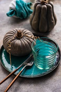 Autumnal table setting with leaves and  pumpkin on wooden table