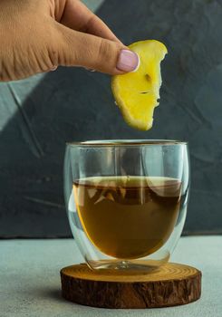 Woman hands and green tea in double glass cup