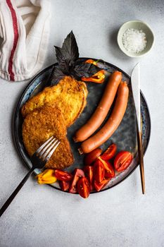 Dinner set with fresh tomatoes, eggs and toasts served on a plate