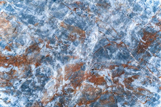 Background of stone surface containing gray, brown, white colors. Top view.