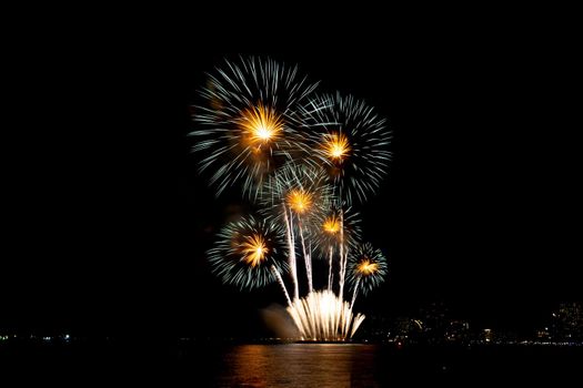 Many flashing colorful fireworks in event amazing with black background celebrate New Year, holiday and festival in night.