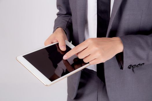 Closeup young asian business man showing and presenting tablet computer with blank screen with success isolated on white background, Hand of businessman using touchpad digital, communication concept.