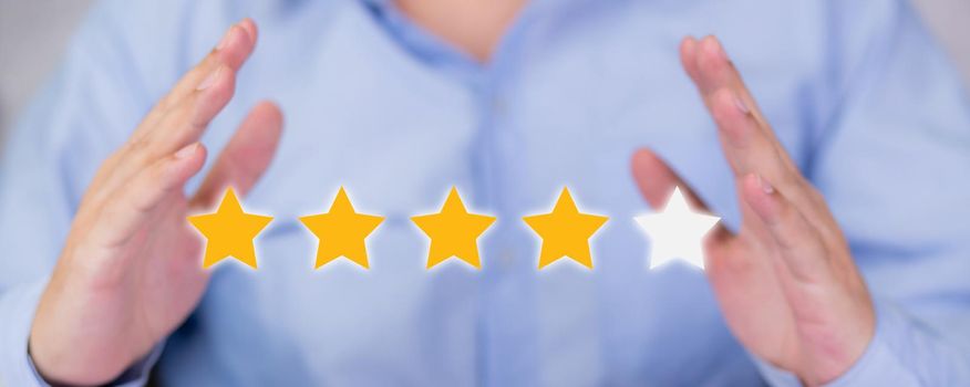 Customer business man holding star icon symbol for vote score review and feedback with quality and satisfaction, success of digital marketing with result excellent for ranking of service.