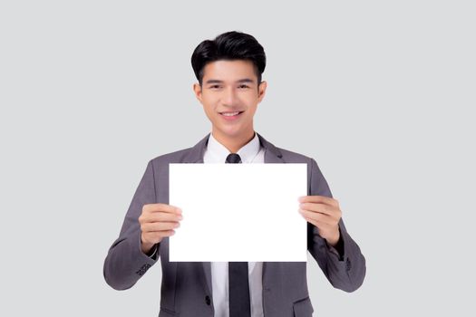 Young asian business man showing empty signboard for advertising isolated on white background, businessman confident holding billboard banner for presenting with copy space, success and achievement.