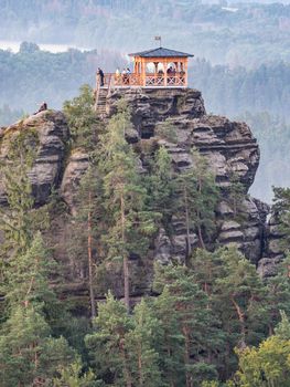 Breakfast or morning picnic of tourists group on popular lookout tower Mariina vyhlidka. The significant viewpoint in Bohemian Switzerland National Park, Czech Republic.