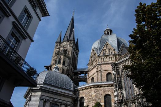 Aachen Cathedral with pointed towers and decorations under the blue sky