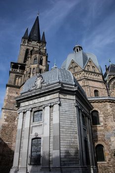 Aachen Cathedral with pointed towers and decorations under the blue sky
