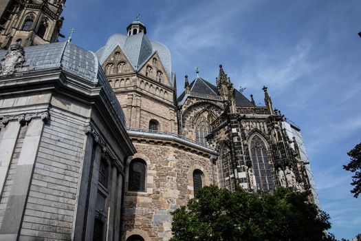 Aachen Cathedral with pointed towers and decorations under the blue sky