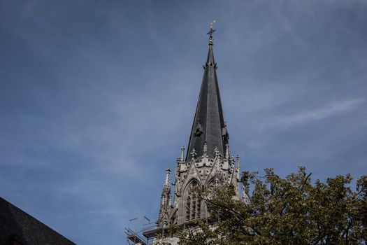 Aachen Cathedral with pointed towers and decorations under the blue sky