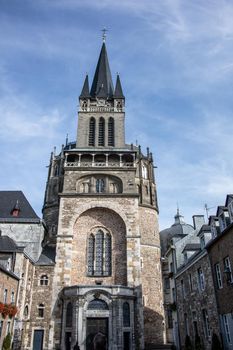 Aachen Cathedral with pointed towers and decorations under the blue sky