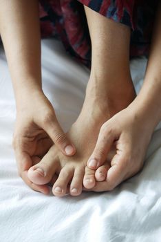 Close up on women feet and hand massage on injury spot
