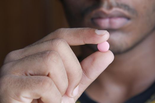 upset man hand holding medical pills .