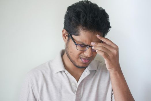Depressed man feeling sick and worried about financial problem.