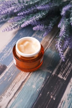 herbal cream cosmetic in a container on table