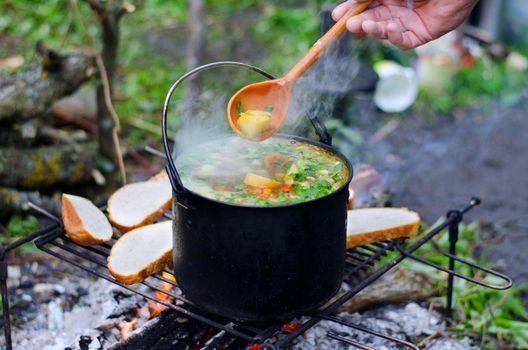 The cooking of soup on the fire