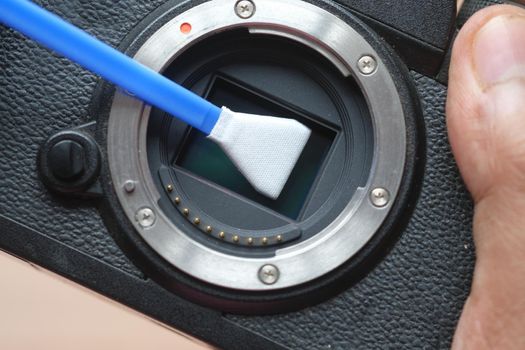 close up of cleaning camera sensor