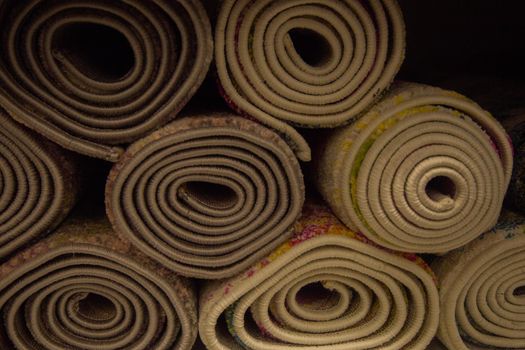A lot of rolled-up carpets. High quality photo