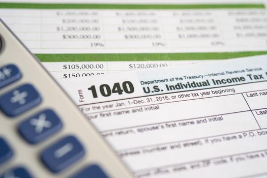 Tax Return form 1040 and dollar banknote, U.S. Individual Income.