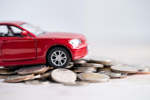 Car on coins background; Car loan, Finance, saving money, insurance and leasing time concepts.