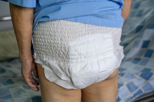 Asian senior or elderly old lady woman patient wearing incontinence diaper in nursing hospital ward, healthy strong medical concept.