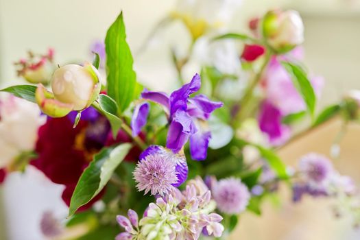 Abstract multicolored floral background texture, close-up flowers and buds peonies irises lupine in defocus, season spring summer, natural beauty, background image