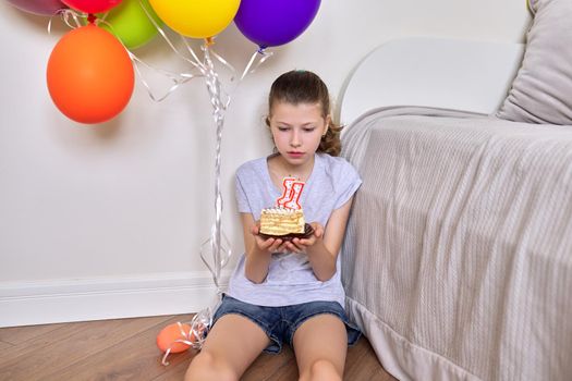 Birthday eleven years old, preteen girl with a small cake and candles 11.