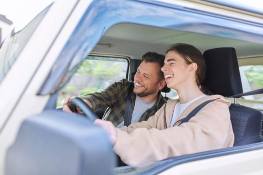 Father teaching his teenage son to drive. Family, relationship middle aged parent teenager, friendship of father and son