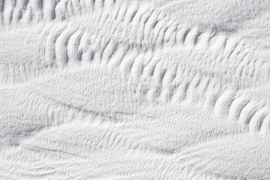 Gray - white texture of Pamukkale calcium travertine in Turkey, abstract pattern, close-up.