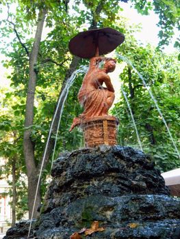 Beautiful decorative bronze fountain in the garden. High quality photo