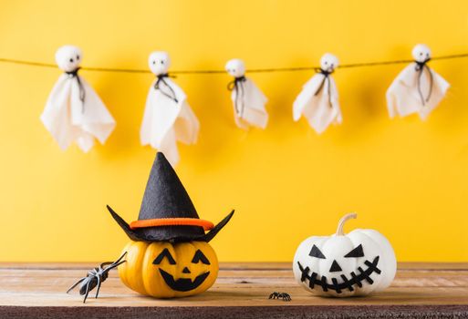 Funny Halloween day decoration party, Baby cute white ghost crafts scary face hanging and halloween pumpkin head jack lantern smile and spider on wooden, studio shot isolated, Happy holiday concept