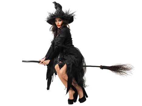 Halloween witch flying on broom studio isolated on white background design element. Beautiful sexy model woman in costume and make up