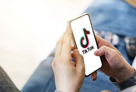 Rome, Italy, June 16th 2021: Woman holding a smart phone with TikTok app on the screen. Social network and internet.