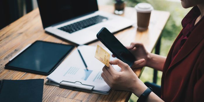 Woman checking her bill of credit card by application on smartphone. Online payment concept