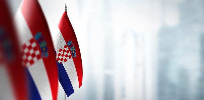Small flags of Croatia on a blurry background of the city.