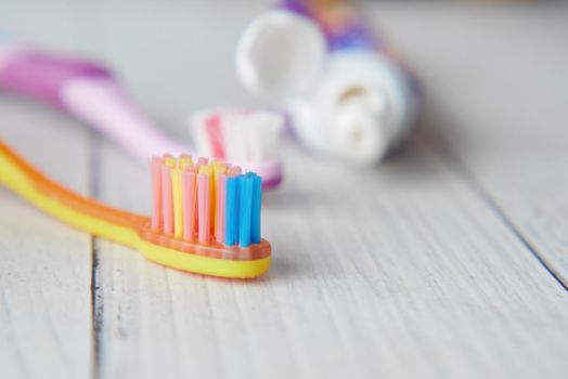 child tooth brush and paste on wooden table ,