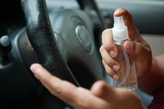 close up of young man hand using hand sanitizer spray