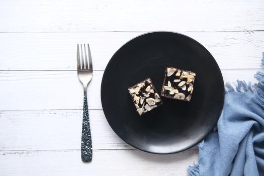 slice of brownie on plate on table .