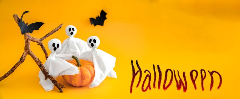 Ghosts, pumpkin and bats on orange background with inscription Halloween. Banner, copy space