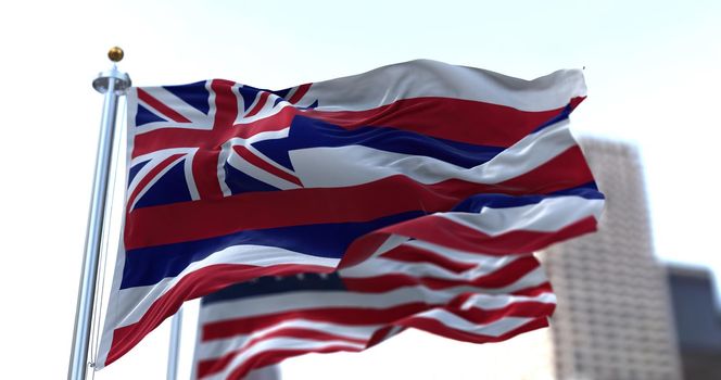 the flag of the US state of Hawaii waving in the wind with the American stars and stripes flag blurred in the background. On August 21, 1959, Hawaii became the 50th state to join the Union