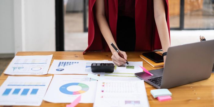 Close-up of a business woman audit the company's budget. Tax information is calculated by accountants