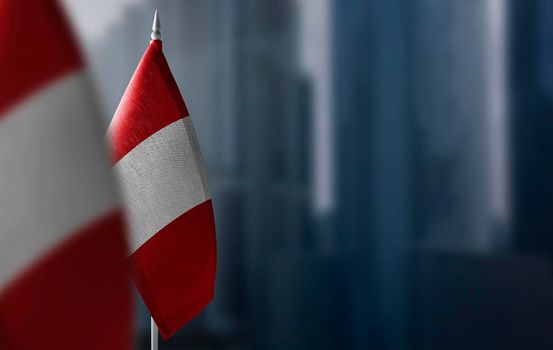 Small flags of Peru on a blurry background of the city.