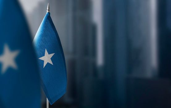 Small flags of Somalia on a blurry background of the city.