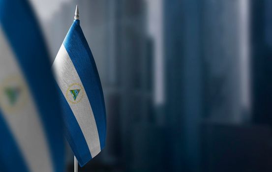 Small flags of Nicaragua on a blurry background of the city.